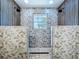 Luxurious walk-in shower features dual shower heads, stylish tile, and ample natural light at 5007 Booth Rd, Plant City, FL 33565