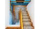 Well-lit staircase with wood banister and carpeted steps leading to the upper level at 5007 Booth Rd, Plant City, FL 33565