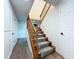 Traditional staircase with wooden banister and carpeted steps, connecting different levels of the home at 5007 Booth Rd, Plant City, FL 33565