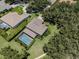 A picturesque aerial view showcasing a single Gathering home with a screened-in pool amidst lush greenery at 5315 Cedarshake Ln, Valrico, FL 33596