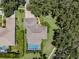 Aerial view of a single Gathering home featuring lush landscaping, mature trees and an inviting screened-in pool at 5315 Cedarshake Ln, Valrico, FL 33596