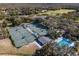 Aerial view of tennis courts, a community pool, and lush greenery offering recreational opportunities at 5315 Cedarshake Ln, Valrico, FL 33596