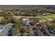 Aerial view of a golf course, clubhouse, and surrounding community with lush landscaping at 5315 Cedarshake Ln, Valrico, FL 33596