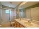 Bathroom featuring double sinks, a shower/tub combo, a decorative curtain, and a large mirror at 5315 Cedarshake Ln, Valrico, FL 33596