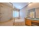 Bathroom featuring a soaking tub with shower and a vanity with dual sinks at 5315 Cedarshake Ln, Valrico, FL 33596