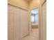Hallway with closet leading to bathroom featuring a soaking tub with window at 5315 Cedarshake Ln, Valrico, FL 33596