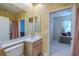 Bathroom sink with vanity looking into bedroom at 5315 Cedarshake Ln, Valrico, FL 33596