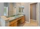 Bathroom featuring a vanity with dual sinks and light yellow tile flooring at 5315 Cedarshake Ln, Valrico, FL 33596
