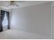 A cozy room featuring carpet, a window with dark curtains and a closet with white trim at 5315 Cedarshake Ln, Valrico, FL 33596