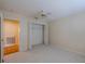 A clean, vacant bedroom features a ceiling fan and an open closet, ready for personalization at 5315 Cedarshake Ln, Valrico, FL 33596