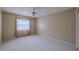 A blank bedroom canvas boasts carpeted floors, a window with curtains, and neutral-colored walls at 5315 Cedarshake Ln, Valrico, FL 33596