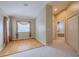Sunlit bedroom with hardwood floors, beige walls, walk-in closet, and large window at 5315 Cedarshake Ln, Valrico, FL 33596