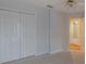 Bedroom view featuring carpet flooring, a ceiling fan, and a door to another room at 5315 Cedarshake Ln, Valrico, FL 33596