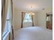 Bright dining room with a chandelier, neutral walls, carpeted flooring, and a window providing natural light at 5315 Cedarshake Ln, Valrico, FL 33596