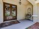 Elegant double front doors adorned with wreaths, a covered porch, and decorative accents at 5315 Cedarshake Ln, Valrico, FL 33596