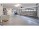 Spacious garage featuring epoxy flooring, utility sink, water heater, and an overhead door with automatic opener at 5315 Cedarshake Ln, Valrico, FL 33596