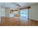Open-concept living room boasts hardwood floors and sliding glass doors to the pool area, perfect for entertaining at 5315 Cedarshake Ln, Valrico, FL 33596