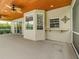 Spacious covered patio with wood plank ceiling, ceiling fans and views of the backyard and screened-in pool at 5315 Cedarshake Ln, Valrico, FL 33596