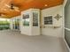 Covered patio features a ceiling fan and views of the yard, providing an inviting space for outdoor living at 5315 Cedarshake Ln, Valrico, FL 33596