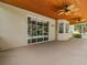Spacious covered patio with wood plank ceiling, ceiling fans and views of the backyard and screened-in pool at 5315 Cedarshake Ln, Valrico, FL 33596
