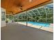 View of a screened-in pool area featuring a wood plank ceiling, ceiling fans and views of the pool and backyard at 5315 Cedarshake Ln, Valrico, FL 33596
