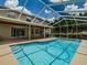 Refreshing swimming pool and screened enclosure with a view of the home, perfect for leisure and entertaining at 5315 Cedarshake Ln, Valrico, FL 33596