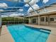 Backyard view of a screened-in pool, lush landscaping and a covered patio, perfect for outdoor entertaining at 5315 Cedarshake Ln, Valrico, FL 33596