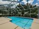 Inviting in-ground screened pool featuring a lounge area, ideal for relaxation and enjoying the outdoors at 5315 Cedarshake Ln, Valrico, FL 33596