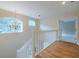 Upstairs landing with hardwood floors, a chandelier, and a view into the bedroom at 5315 Cedarshake Ln, Valrico, FL 33596