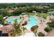 A beautiful community pool with seating, palm trees, and lush landscaping, perfect for relaxation and recreation at 5663 Sunset Falls Dr, Apollo Beach, FL 33572