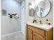 Bright bathroom featuring a single vanity, round mirror, and neutral decor at 5663 Sunset Falls Dr, Apollo Beach, FL 33572