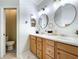 Bright bathroom featuring double sinks, attractive fixtures, and separate toilet room at 5663 Sunset Falls Dr, Apollo Beach, FL 33572