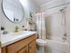 Bathroom featuring attractive fixtures, round mirror, and tub-shower combo at 5663 Sunset Falls Dr, Apollo Beach, FL 33572