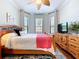 Comfortable bedroom featuring a ceiling fan, dresser, and natural light at 5663 Sunset Falls Dr, Apollo Beach, FL 33572