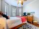 Bright bedroom featuring a ceiling fan, attractive decor, and hardwood flooring at 5663 Sunset Falls Dr, Apollo Beach, FL 33572