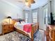 Cozy bedroom with ceiling fan, bay windows, and wood furnishings at 5663 Sunset Falls Dr, Apollo Beach, FL 33572