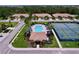 Aerial view of the community pool, tennis courts, and surrounding neighborhood at 5663 Sunset Falls Dr, Apollo Beach, FL 33572
