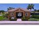 Community pool entrance with beautiful landscaping and secure gate at 5663 Sunset Falls Dr, Apollo Beach, FL 33572