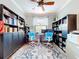 Well-lit home office features dual desks and built-in shelving, ideal for remote work at 5663 Sunset Falls Dr, Apollo Beach, FL 33572