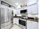 Bright kitchen featuring white cabinets, stainless steel appliances, and modern fixtures at 5663 Sunset Falls Dr, Apollo Beach, FL 33572