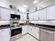 Modern kitchen showcasing stainless steel appliances and white cabinets, maximizing storage at 5663 Sunset Falls Dr, Apollo Beach, FL 33572