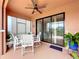 Covered lanai with an outdoor dining set and view of the backyard landscape at 5663 Sunset Falls Dr, Apollo Beach, FL 33572