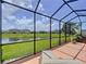 Enclosed lanai overlooking a pond, offering a peaceful outdoor living space at 5663 Sunset Falls Dr, Apollo Beach, FL 33572