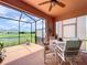 Screened lanai featuring outdoor dining and a view of the lush lawn and pond at 5663 Sunset Falls Dr, Apollo Beach, FL 33572