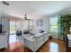 Spacious living room with hardwood floors, comfortable seating, and natural light at 5663 Sunset Falls Dr, Apollo Beach, FL 33572
