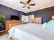 Spacious main bedroom with wood floors, ceiling fan and ensuite bathroom at 5663 Sunset Falls Dr, Apollo Beach, FL 33572