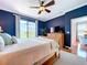 Comfortable main bedroom featuring a ceiling fan, TV, and a view to the exterior at 5663 Sunset Falls Dr, Apollo Beach, FL 33572