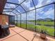 Spacious screened-in patio with a beautiful lake view, perfect for outdoor enjoyment and relaxation at 5663 Sunset Falls Dr, Apollo Beach, FL 33572