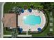 A sparkling community pool, surrounded by lounge chairs and umbrellas, offering a perfect oasis for relaxation and recreation at 5663 Sunset Falls Dr, Apollo Beach, FL 33572