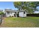 Exterior view of the backyard with green lawn and storage shed at 5906 12Th St, Zephyrhills, FL 33542